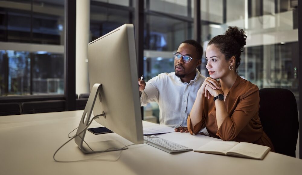 two people looking a computer screen
